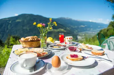 a table with breakfast foods and eggs on it at Gasthaus Gasteiger in Lagundo