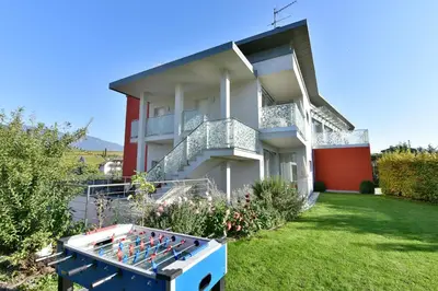 a house with a box of bottles in the yard at Arboris Appartement in Appiano sulla Strada del Vino