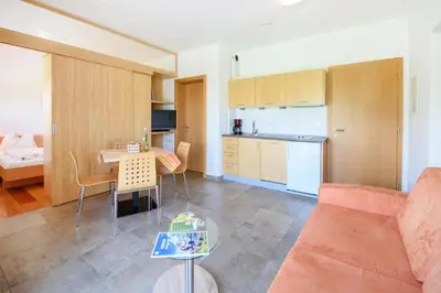 a living room with a couch and a table at Arboris Appartement in Appiano sulla Strada del Vino