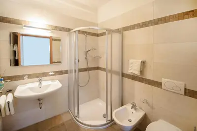 a bathroom with a shower and a toilet and a sink at Arboris Appartement in Appiano sulla Strada del Vino