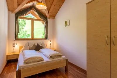 a bedroom with a bed with a window and a window at Solerhof in Laion