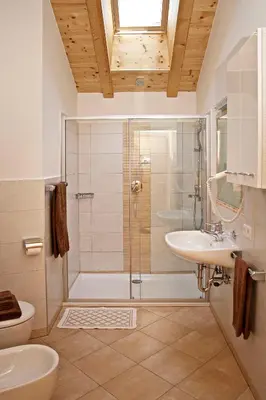 a bathroom with a shower and a sink and a toilet at Solerhof in Laion