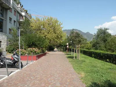 a cobblestone walkway next to a building at Nel Cuore Verde di Bolzano in Bolzano