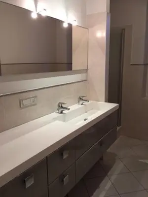 a bathroom with two sinks and a mirror at Nel Cuore Verde di Bolzano in Bolzano