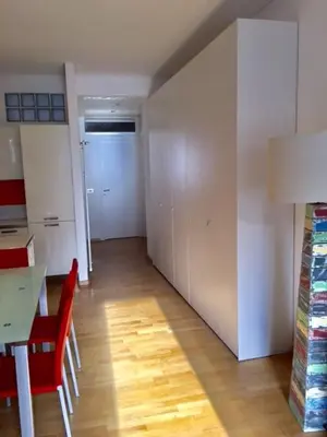 a room with a table and chairs and a hallway at Nel Cuore Verde di Bolzano in Bolzano