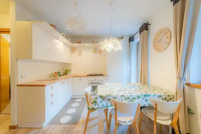 a kitchen and dining room with a table and chairs at Appartamento Lucia in Penia