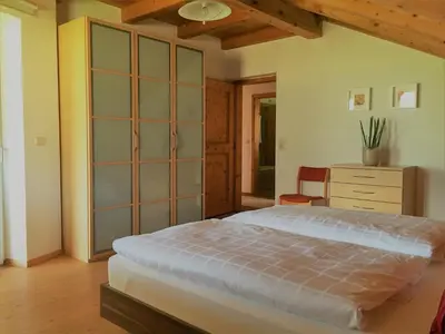a bedroom with a bed and a dresser in it at Ferienwohnung Eichnerhof in Magrè allʼ Adige