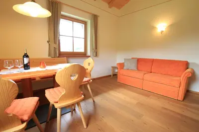 a large kitchen with wooden cabinets and a window at Paalhof in Castelrotto
