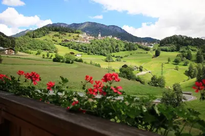 a kitchen with wooden cabinets and a large window at Paalhof in Castelrotto