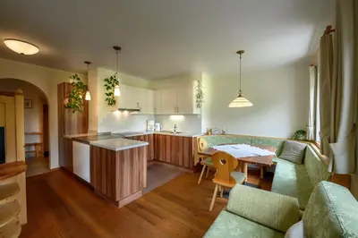 a kitchen and living room with a couch and a table at Paalhof in Castelrotto