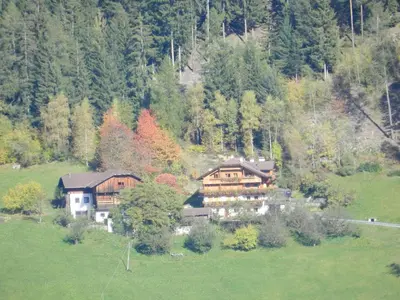 a large house in the middle of a field at Gedrarzerhof in Luson