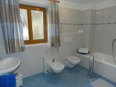 a bathroom with a toilet and a tub and a sink at Gedrarzerhof in Luson
