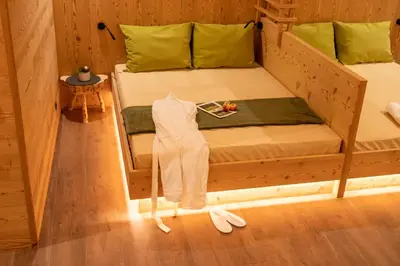 a bedroom with two bunk beds and a table at Leitenhof in Val di Vizze