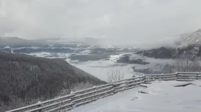 a view of a valley in the mountains with snow at Arche Hof Bichler in Gais