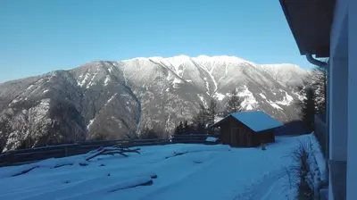 a barn in the snow in front of a mountain at Arche Hof Bichler in Gais