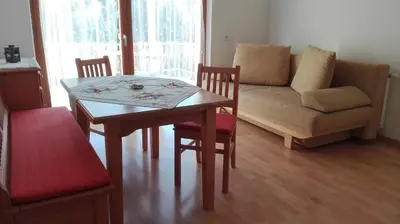 a living room with a table and a couch at Arche Hof Bichler in Gais