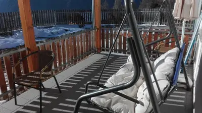 a porch with two chairs and a mattress on it at Arche Hof Bichler in Gais