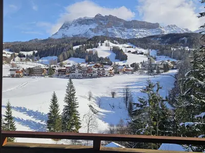 a village in the snow with a mountain at Pension Atlantic in Badia