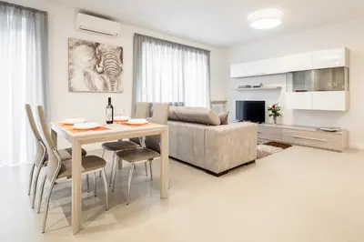 a living room with a table and a couch at Fior Apartments in Merano