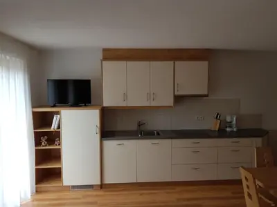 a kitchen with white cabinets and a sink at Ferienwohnungen Schlosshäusl in San Lorenzo di Sebato