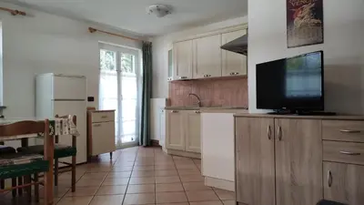a kitchen with a flat screen tv on a counter at Cesa Stefi in Canazei