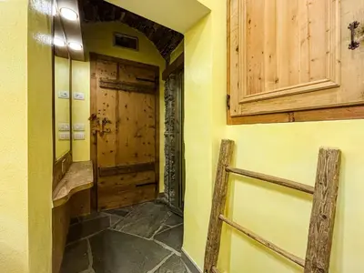 a hallway with a door in a room with yellow walls at Apartment Dolavilla in Canazei