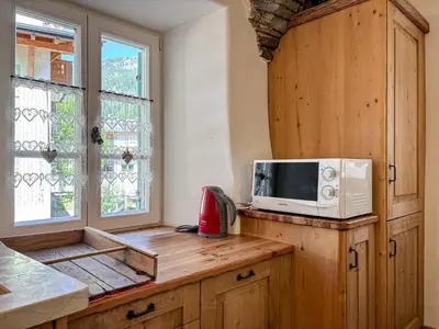 a kitchen with a microwave on top of a counter at Apartment Dolavilla in Canazei