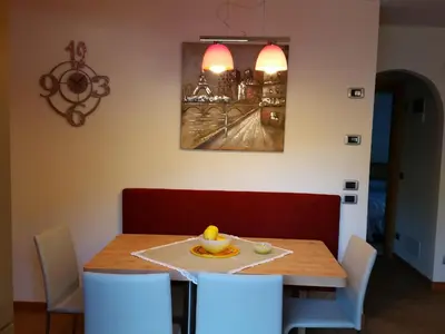 a dining room table and chairs with a plate of fruit on it at Casa Alice 5.5 in Fiera di Primiero