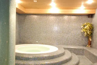 a bathroom with a large bath tub in a room at Garni Cristallo in San Vigilio Di Marebbe