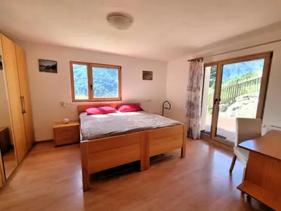 a bedroom with a bed with red pillows on it at Casa Simona in Sorafurcia
