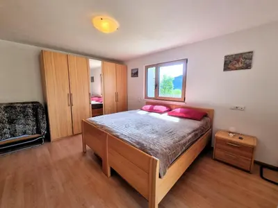 a bedroom with a large bed with red pillows at Casa Simona in Sorafurcia