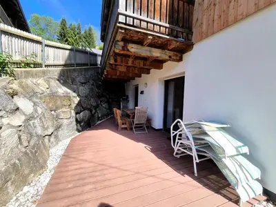 a patio with a table and chairs and a balcony at Casa Simona in Sorafurcia