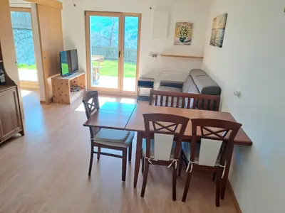 a living room with a dining room table and chairs at Casa Simona in Sorafurcia