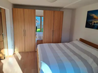 a bedroom with a bed and some wooden cabinets at Casa Simona in Sorafurcia
