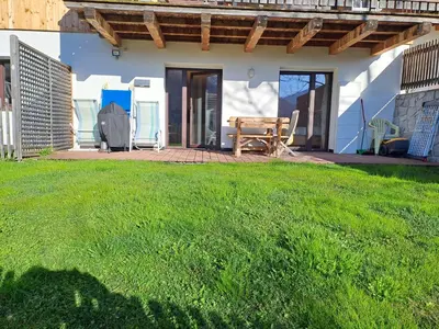 a patio with a table and chairs on a lawn at Casa Simona in Sorafurcia