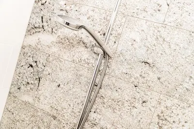 a shower head on the floor of a bathroom at Nutzhof - Mediterran Flair Hotel in Lagundo