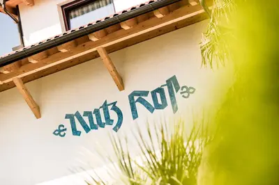 a sign on the side of a building at Nutzhof - Mediterran Flair Hotel in Lagundo