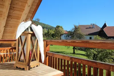 a porch of a cabin with a view of a house at Apartments Im Winkl in Brunico