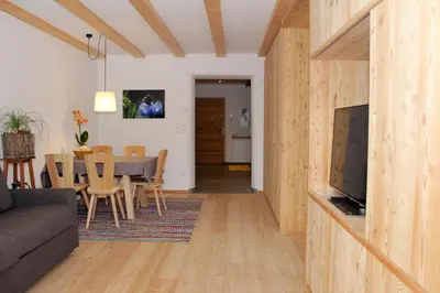 a living room with a couch and a dining room at Apartments Im Winkl in Brunico