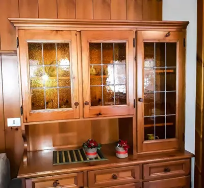 a wooden hutch with glass windows in a room at Sas da Rocia by go new location in Soraga
