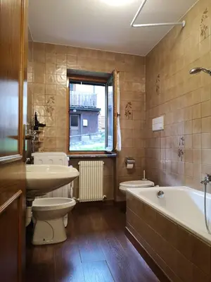 a bathroom with a tub and a toilet and a sink at Sas da Rocia by go new location in Soraga