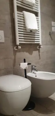 a bathroom with a toilet and a sink and a tub at Appartamento Dolomiti in Selva di Val Gardena