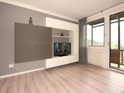 a living room with a tv on a wall at Appartamento Dolomiti in Selva di Val Gardena
