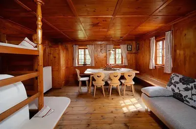 a room with a table and chairs in a cabin at Berg-Weiler-Obereggerhof in Schenna