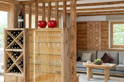 a wine cellar with a wall of wine glasses at Berg-Weiler-Obereggerhof in Schenna