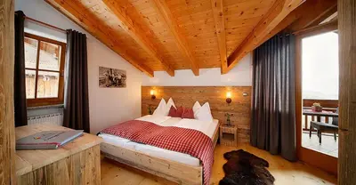 a bedroom with a bed and a large window at Berg-Weiler-Obereggerhof in Schenna