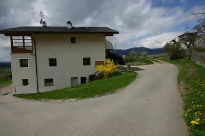 a small white building on the side of a road at Hilpoldhof in Castelrotto