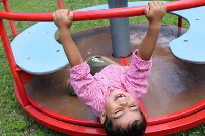 a young girl is playing on a playground at Untertalhof in Castelrotto