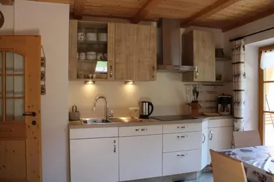 a kitchen with white cabinets and a sink at Untertalhof in Castelrotto