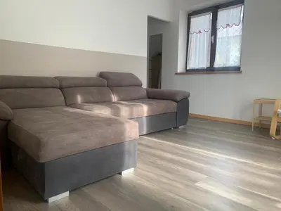 a living room with a couch and a table at Appartamento Piè in Canazei
